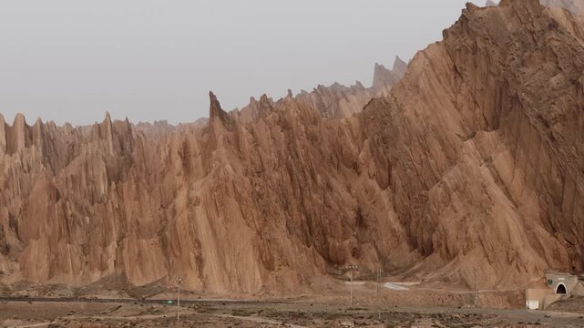 Aerial view of the Hongshan Stone Forest's jagged peaks and rugged terrain, a geological masterpiece of contrasting textures and earthy tones, Kuqe, China.