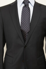 Man in a black suit and tie