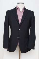 Navy blue blazer and checkered shirt on a mannequin