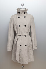 Elegant beige trench coat displayed on a mannequin
