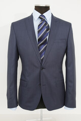 Elegant navy suit on a mannequin, showcasing formal menswear.