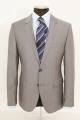 Elegant grey suit displayed on a mannequin, perfect for formal occasions.