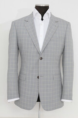 Elegant gray plaid suit jacket on a mannequin