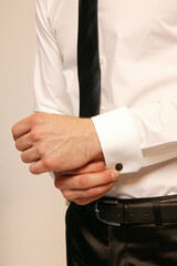Man adjusting his cufflink