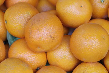 Fresh oranges piled up at market stall