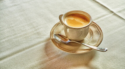 After Lunch Ceramic Cup of Coffee on Table with Tablecloth