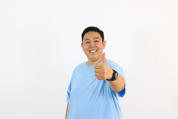 Happy man giving thumbs up gesture showing positive attitude and approval