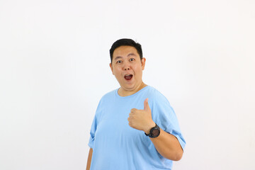 Smiling man giving thumbs up against a white background