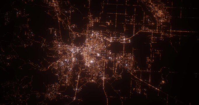 Rapid City (South Dakota, USA) aerial view at night. Top view on modern city with street lights. Camera is zooming out, rotating clockwise