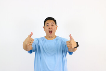 Excited young asian man with thumbs up
