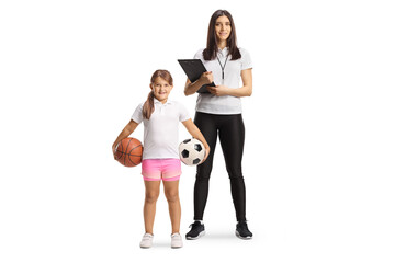 Female sports coach and girl holding football and basketball