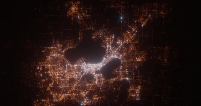 Madison (Wisconsin, USA) aerial view at night. Top view on modern city with street lights. Camera is flying above the city, moving backward