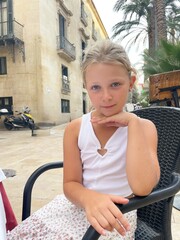 Portrait of a teenage girl in a street restaurant