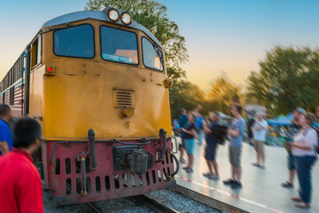 Train locomotive arrive to train rail station at historic bridge on river Kwai, Thailand