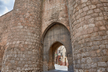 Naklejka premium A journey into the past through the Puerta de Herreros, Almazan, Soria, with its stone arches and towers