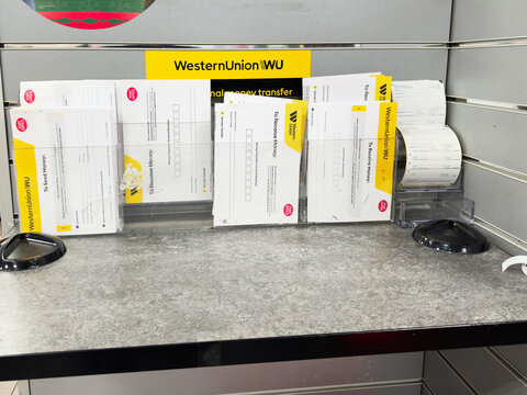 Western Union money transfer forms and receipts on a service desk for easy processing