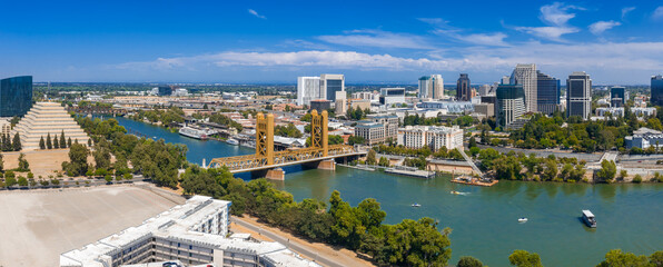 Aerial view of Sacramento, California, featuring the golden Tower Bridge, Sacramento River,...