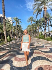 woman walking along the promenade of Alicante