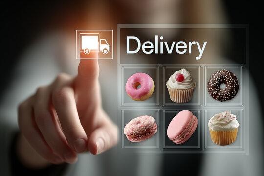 Modern digital interface for food delivery with food delivery car icon , finger touching virtual menu icons of bakery items such as cake, donut, cupcake, and macarons, bakery and sweet shop apps.