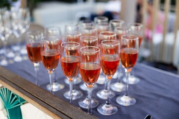 Chilled glasses of rosé champagne ready for guests
