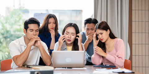 Stressed  team thinking of problem solution at office meeting room , sad business people group shocked by bad news, upset colleagues in panic after company bankruptcy lay off concept.