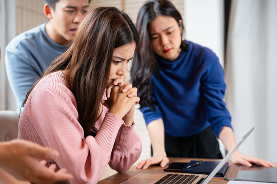 Stressed  team thinking of problem solution at office meeting room , sad business people group shocked by bad news, upset colleagues in panic after company bankruptcy lay off concept.