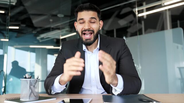 Webcam view. Angry businessman arguing talking on video call looking in camera in office. Nervous dissatisfied manager solving stressful business situation conflict resolution. Boss scolds subordinate