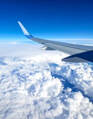 Plane view wing above clouds, blue sky above