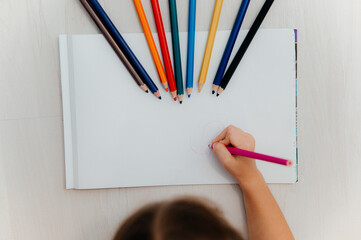 Little girl drawing greeting card on table. Father's day concept