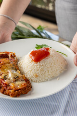 Serving chicken parmesan with rice dinner plate