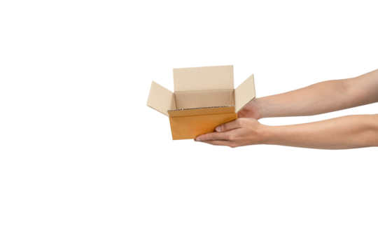 This is a photograph of an open, empty light-brown cardboard box being held by two hands  against a clean, isolated white background. The image clearly communicates delivery, receiving, giving, or unb