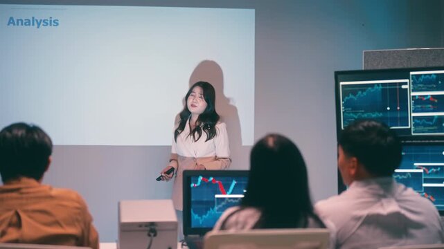 Asian business woman presentations slides chart graphs of work professionals collaborating on a late-night project meeting in a modern office. Brainstorming innovative ideas for a new business .