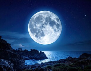 Majestic Full Moon Over Rocky Coastline at Night in Blue Tones Stars Shine in Dark Sky Reflected on Ocean Surface Ethereal Moonlight Landscape