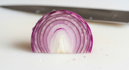 A  captures a halved red onion, revealing its concentric layers of purplish-red and white.