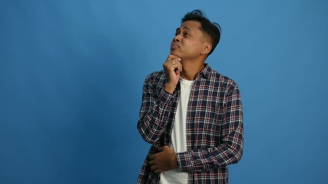 Minded smart young asian man finger chin look empty space creative problem solution concept