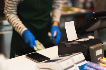 Selected focus Credit card payment and bill for purchase with cashier in blru background.