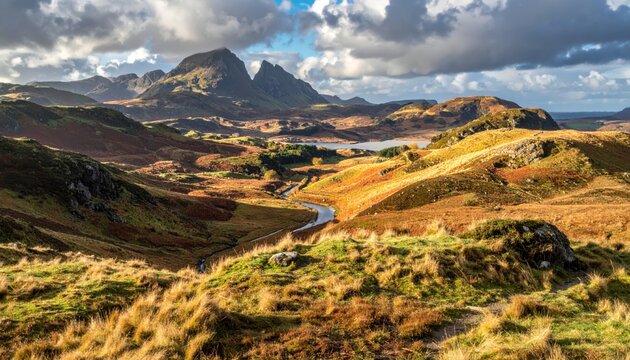 Majestic mountain peaks dominate the landscape, with golden-brown rolling hills and valleys stretching towards the horizon under a dramatic, cloudy sky, showcasing the natural beauty of a remote,... - Powered by Adobe