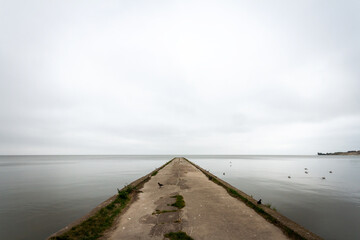 Old concrete pier under a cloudy sky in Nida, Curonian Spit and Curonian Lagoon, Lithuania
