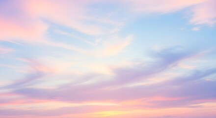 Fototapeta premium Serene pastel sunset sky with wispy clouds, creating a tranquil atmosphere for relaxation
