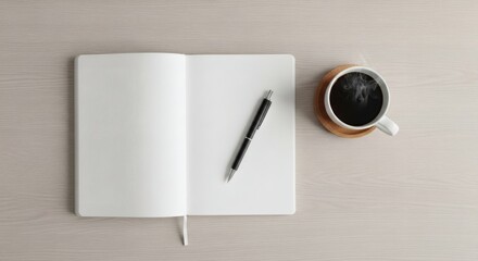 Open notebook with pen and coffee cup on a neutral surface
