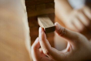 Closeup hand holding wooden block game