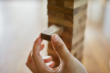 Closeup hand holding wooden block game