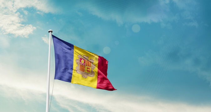 Andorra national flag fluttering. The flag blowing in beautiful soft sky. Andorra national flag for independence day. - Powered by Adobe