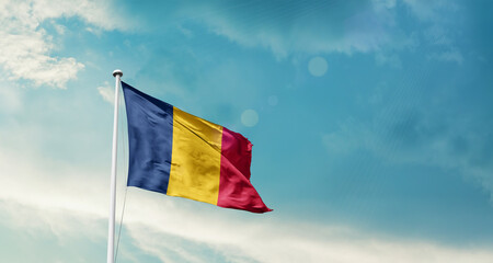 Chad national flag fluttering. The flag blowing in beautiful soft sky. Chad national flag for independence day.