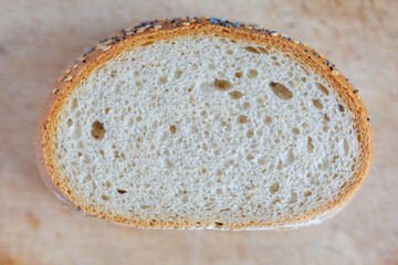 Fresh sliced bread with sesame and poppy seeds, close up