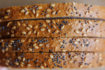 Sliced bread with sesame and poppy seeds, homemade bread baking