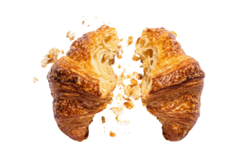 Two halves of a golden croissant, broken open, reveal a light interior.  Crumbs scattered
