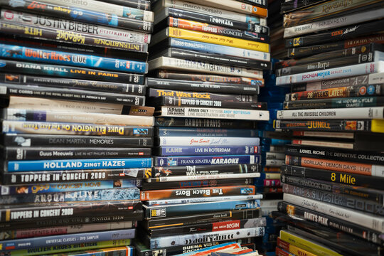 Stack pile of different dvd's, music and films in a local dutch store. 