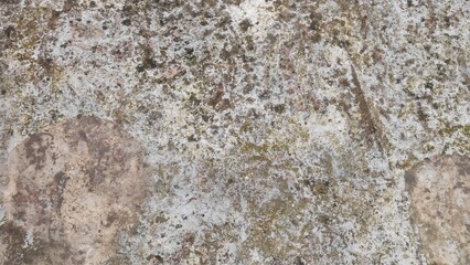 Old, natural stone wall texture pattern with rough gray granite and cement detail.