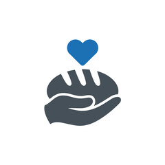 Obraz premium Hand holding bread with heart, symbol of charity, donation, and food bank for people in need